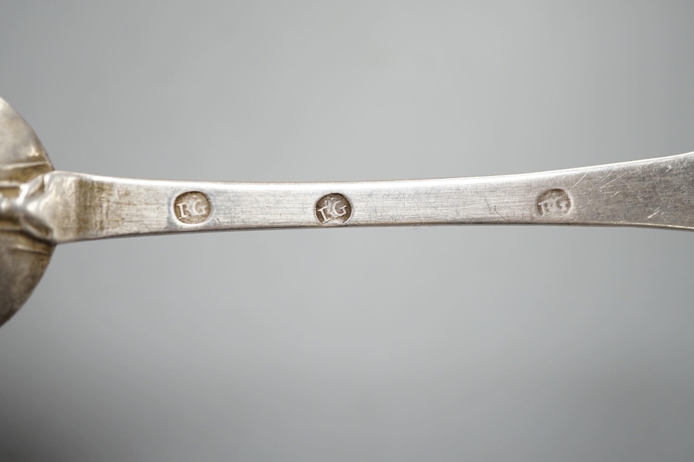 An early 18th century white metal rat tail dog nose spoon, stamped with maker's mark RG below two pellets three times, with prick dot initial and date, 20.6cm, 55 grams.